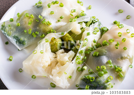 Close-up of cut spring roll with broccoli, cauliflower and brussels sprouts 103583883