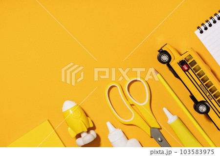 Assorted office and school white and yellow stationery. copy space for back to school or education craft office work concept. Bright Yellow monochrome school bus, rocket. Achievement and success. Assorted office and school white and yellow stationery. copy space for back to school or education craft office work concept. Bright Yellow monochrome school bus, rocket. Achievement and success. 103583975