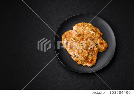 Delicious fried chicken breast in batter with mustard, salt, spices and cheese 103584400