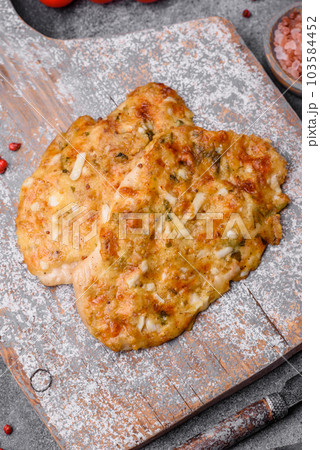 Delicious fried chicken breast in batter with mustard, salt, spices and cheese 103584452
