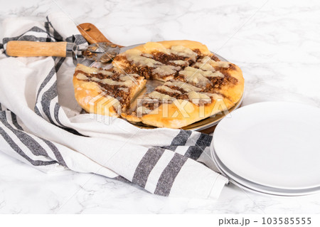 Freshly baked cinnamon dessert pizza with cream cheese drizzle. 103585555