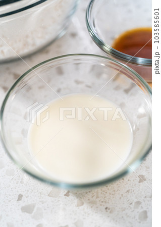 Measured ingredients in glass mixing bowls to make the vanilla glaze for bundt cake. 103585601