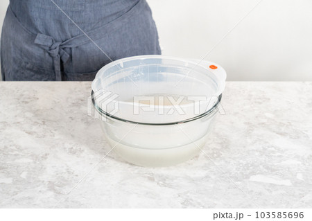 Washing dry rice in a rice washer and large glass bowl. 103585696