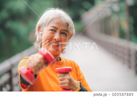 white-haired elderly person exercising in the park early in the morning. white-haired elderly person exercising in the park early in the morning. 103587885