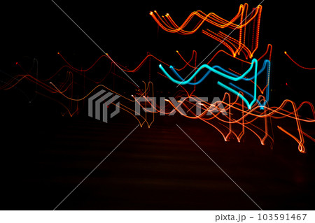 Long exposure, light painting photography, multi color swirl effect against black background. Night city lights Long exposure, light painting photography, multi color swirl effect against black background. Night city lights 103591467