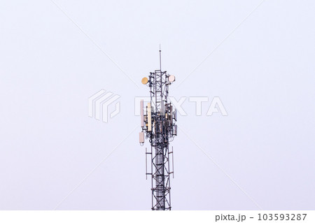 Telecommunication tower. Wireless Communication Antenna Transmitter with antennas bright sunlight and sky background. Telecommunication tower 4G, 5G cellular Base Station or Base Transceiver Station.  103593287