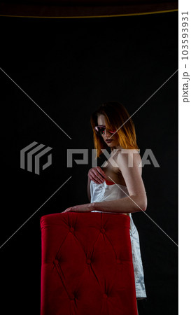woman in white dress on red chair woman in white dress on red chair 103593931