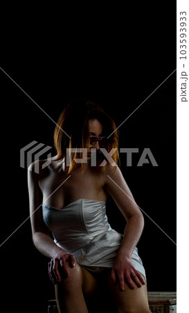 woman in white dress on red chair woman in white dress on red chair 103593933