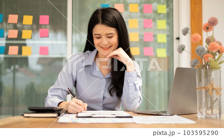 Asian businesswoman sit at their desks and calculate financial graphs showing results about their investments, plan a successful business growth process Asian businesswoman sit at their desks and calculate financial graphs showing results about their investments, plan a successful business growth process 103595290