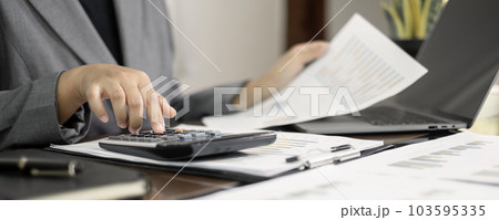 Businesswomen or accountants working on financial investment, calculating, analyzing, and marketing on graphs showing the results of their investments to plan a successful business growth process 103595335