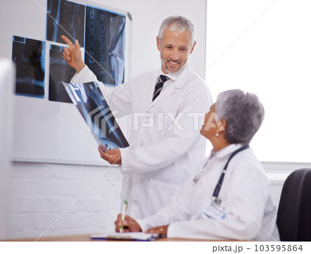 Senior team of doctors, study xray for surgery and people in radiology with healthcare in clinic. Review anatomy scan, old man and woman surgeon collaboration with assessment and problem solving 103595864