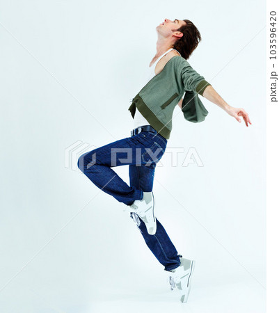 Man, jump and dance in the air for happiness with action, movement and balance of body isolated on white studio background. Male ballet dancer, happy and free with energy or dancing to music for fun 103596420