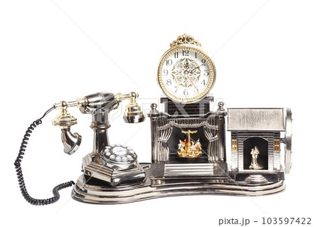 Vintage telephone with antique clock isolated on white Vintage telephone with antique clock isolated on white 103597422