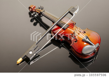 Violin with bow on black background. Violin with bow on black background. 103597506