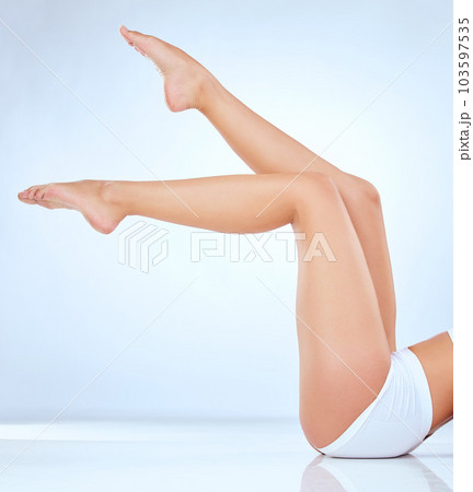 She just shines. Shot of an unrecognisable woman showing her legs while posing in the studio. She just shines. Shot of an unrecognisable woman showing her legs while posing in the studio. 103597535