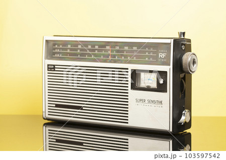 Old transistor radio on a yellow background Old transistor radio on a yellow background 103597542