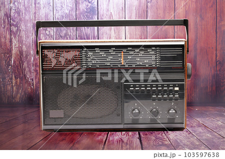 old transistor radio on a wooden background 103597638