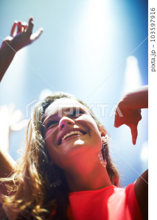 Music, dance and party with woman at concert for rock, live band performance and festival show. New year, celebration and disco with girl in crowd of fans for techno, rave and nightclub event Music, dance and party with woman at concert for rock, live band performance and festival show. New year, celebration and disco with girl in crowd of fans for techno, rave and nightclub event 103597916