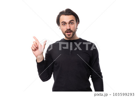 young handsome brunet european man in a black sweatshirt enthusiastically communicates an idea on an young handsome brunet european man in a black sweatshirt enthusiastically communicates an idea on an 103599293