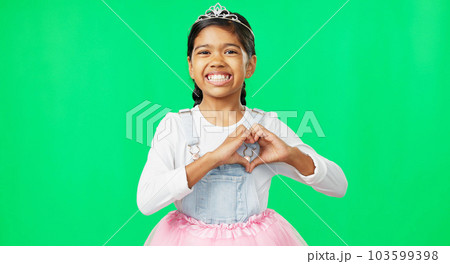 Heart, green screen and love hand gesture by child excited, smile and excited isolated in studio background. Young, care and support sign by girl or kid in princess costume or tutu showing symbol 103599398