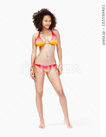 Portrait, black woman and bikini in studio for summer, vacation and fun while posing on white background space. Model, swimwear and girl from Jamaica standing confident, proud and cool isolated 103599401