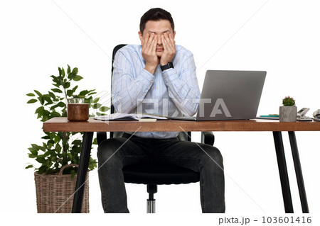 man have a headache, using laptop in office 103601416