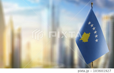 A small Kosovo flag on an abstract blurry background A small Kosovo flag on an abstract blurry background 103601927