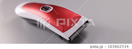 Red hair clipper on a gray background 103602534