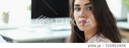 Woman holds musical notes and plays home synthesizer Woman holds musical notes and plays home synthesizer 103602808