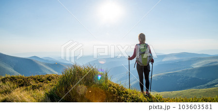 Young woman hiking in the mountains Young woman hiking in the mountains 103603581