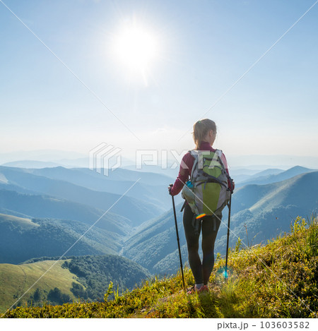 Young woman hiking in the mountains Young woman hiking in the mountains 103603582