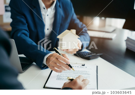Considering buying a home, investing in real estate. Broker signs a sales agreement. agent, lease agreement, successful deal. Considering buying a home, investing in real estate. Broker signs a sales agreement. agent, lease agreement, successful deal. 103603645