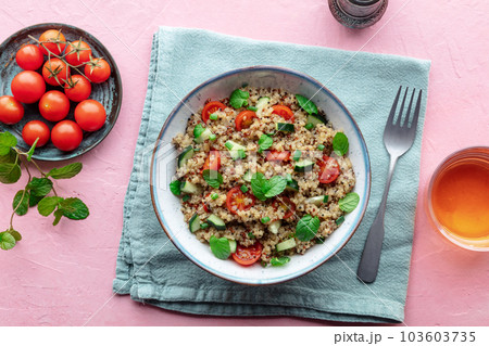 Quinoa tabbouleh salad in a bowl, a healthy dinner with tomatoes and mint 103603735