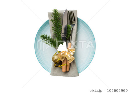 isolated christmas Plate with decor and fork and spoon. New year holiday background. Top view 103603969