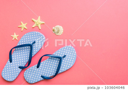 Flat lay composition with flip flops and seashell on colored background. Space for text top view Flat lay composition with flip flops and seashell on colored background. Space for text top view 103604046