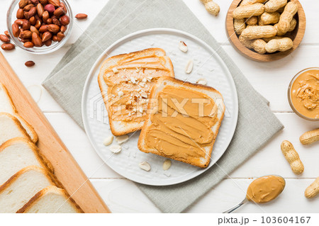 Peanut butter sandwiches or toasts on light table background.Breakfast. Vegetarian food. American cuisine top view vith copy space 103604167