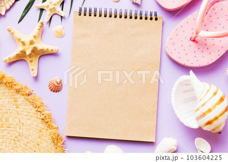 Blank writing book with summer beach accessories on background, copy space. Flat lay with copy space Blank writing book with summer beach accessories on background, copy space. Flat lay with copy space 103604225