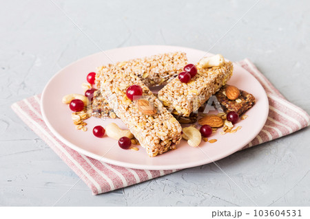 Various granola bars on table background. Cereal granola bars. Superfood breakfast bars with oats, nuts and berries, close up. Superfood concept 103604531
