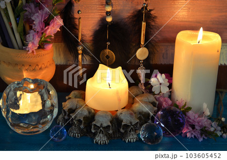 Burning candles on witch ritual table. Occult, esoteric and divination still life. Mystic background with vintage objects 103605452
