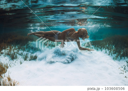 Blonde woman swimming underwater in blue ocean. Snorkeling in Mauritius or Bali 103608506