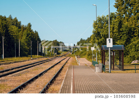 Platform of a train station with empty railway tracks Platform of a train station with empty railway tracks 103608598