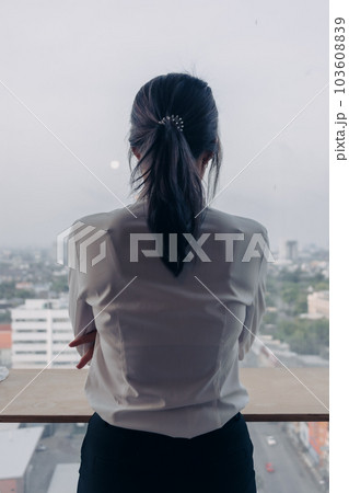 Business woman inteupreneur standing by the windows with city veiw. Business woman inteupreneur standing by the windows with city veiw. 103608839