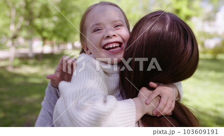 happy family park. mother hugs running cheerful child. portrait kid child girl smile. happy affectionate mother park proroda walk daughter. adoptive parent. adorable little child girl hugging her mom happy family park. mother hugs running cheerful child. portrait kid child girl smile. happy affectionate mother park proroda walk daughter. adoptive parent. adorable little child girl hugging her mom 103609191
