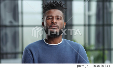 Confident black business man looking at camera with serious expression Confident black business man looking at camera with serious expression 103610134