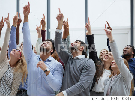 happy group of diverse young people holding their hands up 103610845