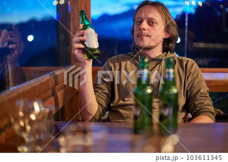 Man drinking beer in pub Man drinking beer in pub 103611345