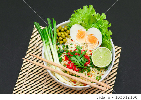Beautiful Noodle Dish with Green Onions, Eggs, Red Hot Pepper and Greens 103612100