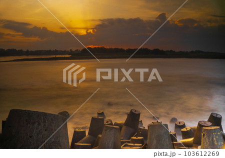 Tetrapods or breakwaters on the Glagah Beach, Kulonprogo, Indonesia during sunrise. 103612269