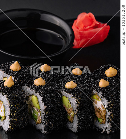 Sushi rolls with tuna and caviar on black plate Sushi rolls with tuna and caviar on black plate 103613269