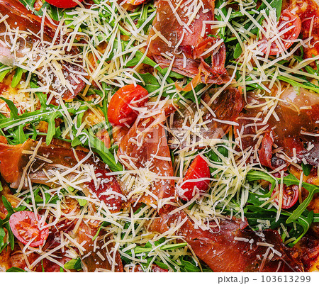 Italian pizza with prosciutto, arugula and tomatoes Italian pizza with prosciutto, arugula and tomatoes 103613299